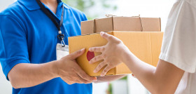 Woman hand accepting a delivery of boxes from deliveryman