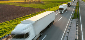 Delivery transport trucks on the highway at idyllic morning