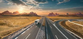 Lone white truck on highway at idyllic sunset