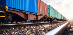 Train wagons carrying cargo containers for shipping companies